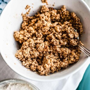 Spoon in a bowl of vegan walnut taco meat.