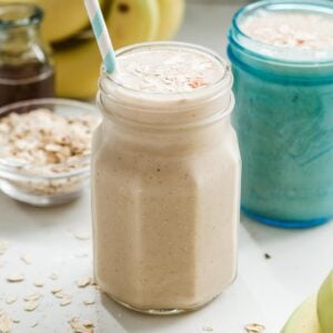 Two jars with banana oatmeal smoothie.