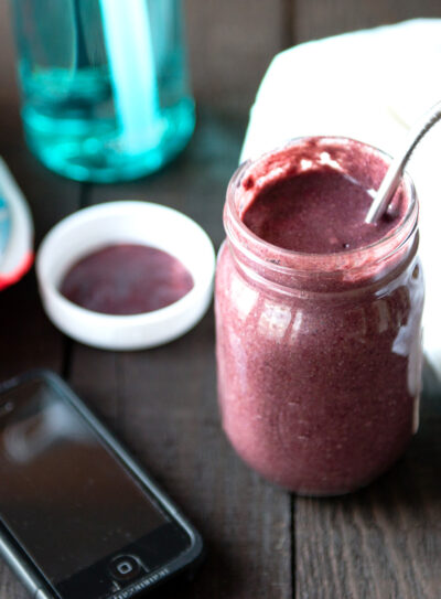 post workout smoothie with water bottle and running shoes.