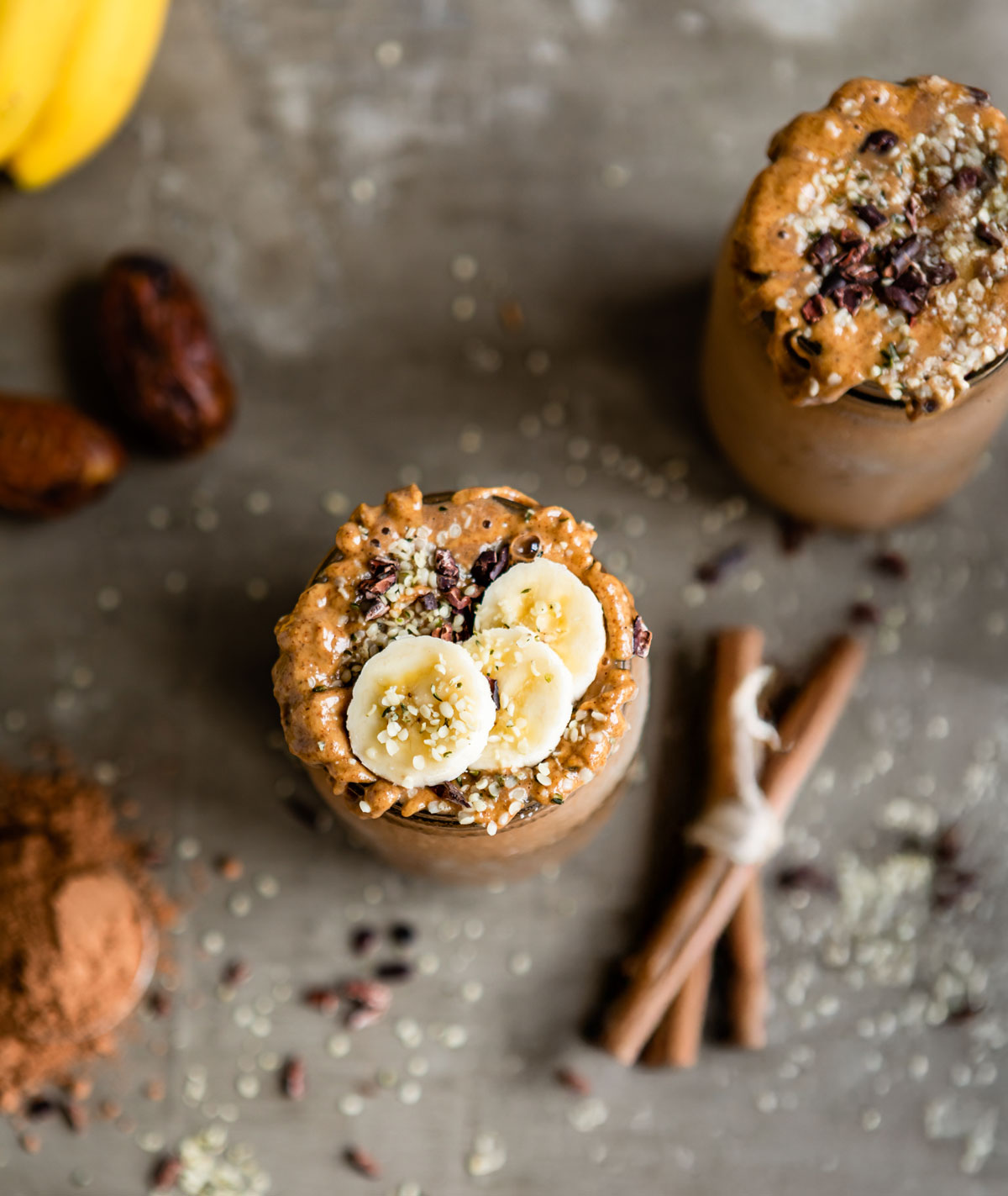Two jars filled with banana chocolate protein shake.