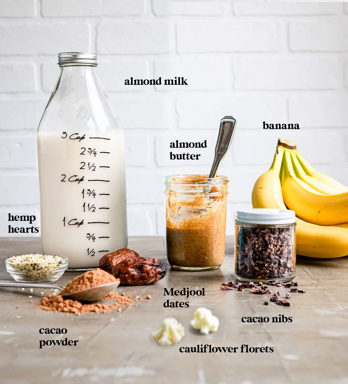 Ingredients on counter to make banana chocolate protein shake recipe.