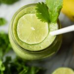 Cilantro smoothie topped with a lime slice.