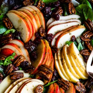 Fall salad with thinly-sliced apples, nuts, and greens.