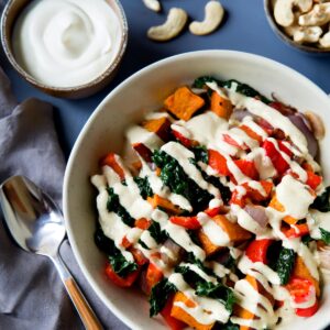 Bowl of vegetables topped with a hemp heart sauce.