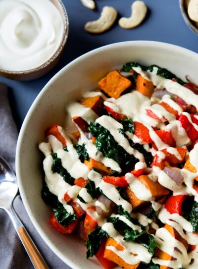 Bowl of vegetables topped with a hemp heart sauce.