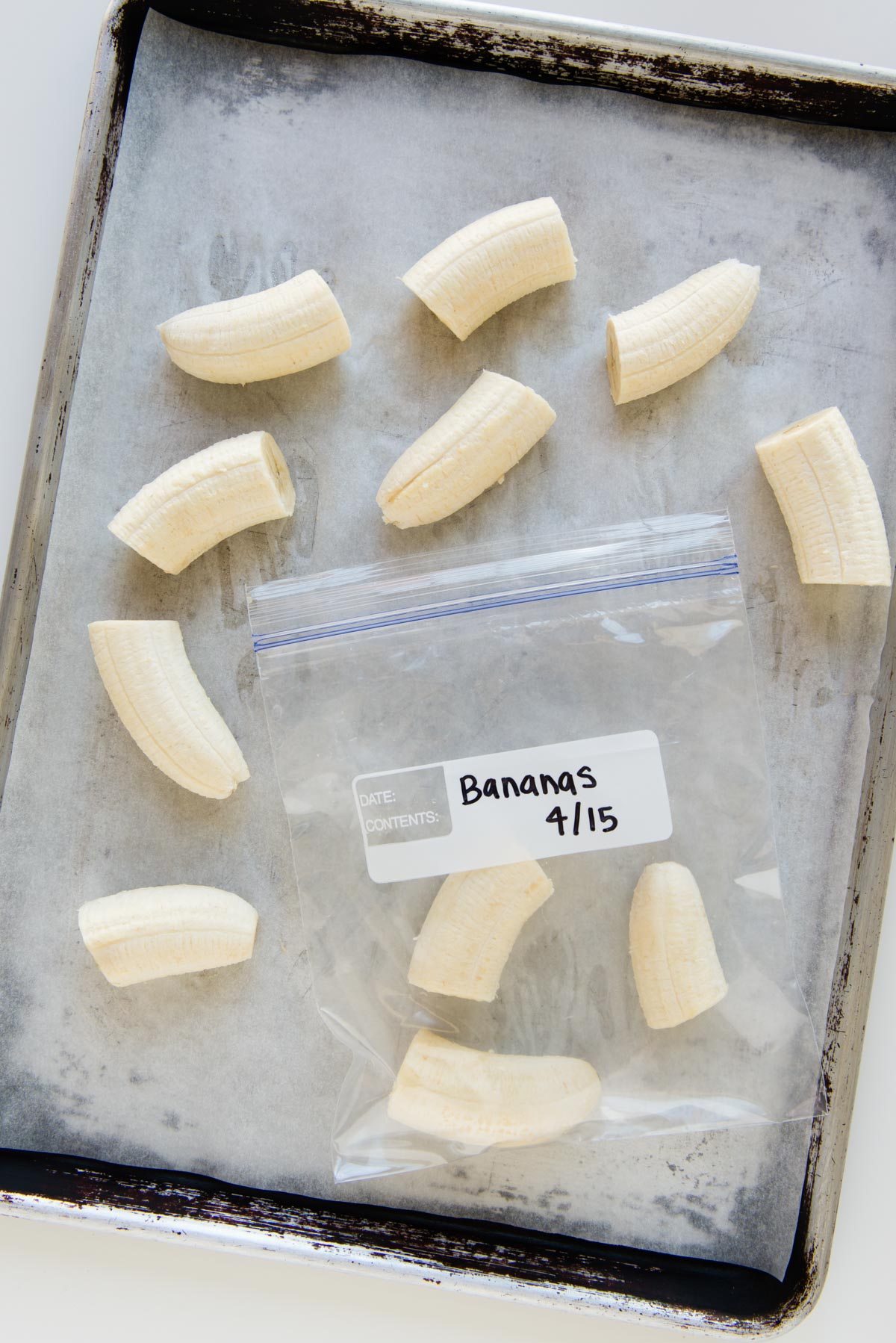 Frozen banana pieces going into a freezer safe bag