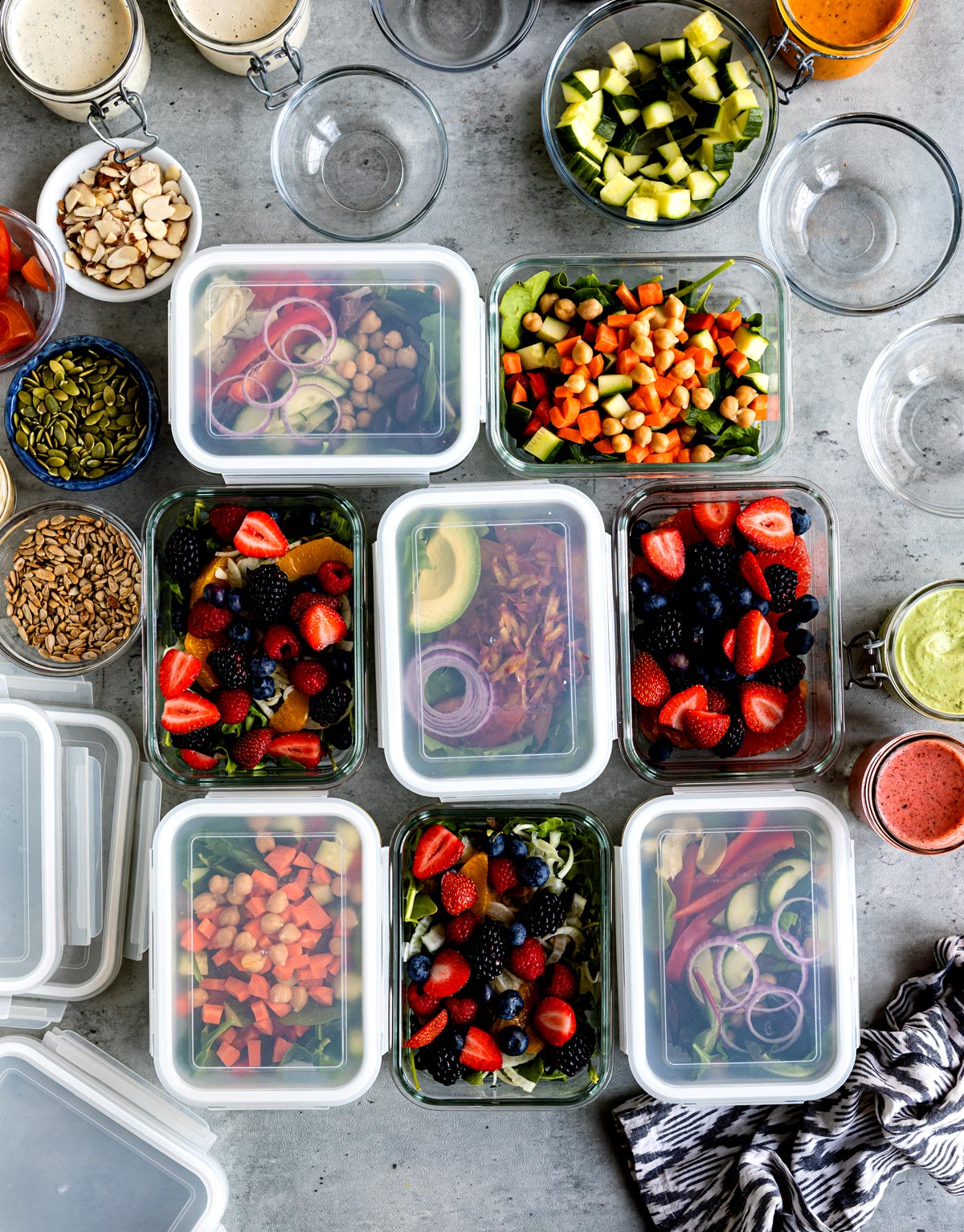 Several glass containers of colorful foods.