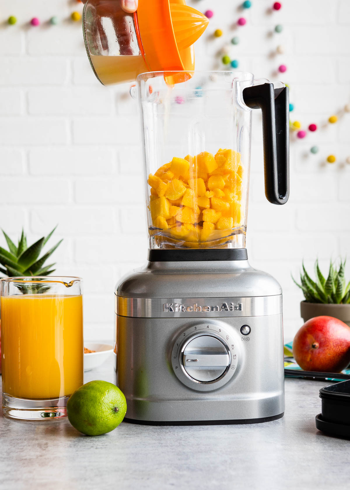 Lime juice being poured into a blender.