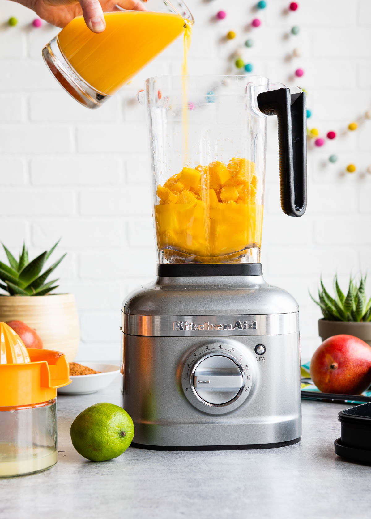 Orange Juice being poured into a blender.