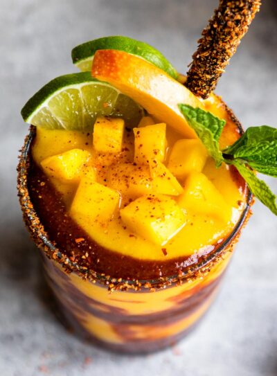 A glass of mangonada recipe with chamoy sauce and tamarind straw.