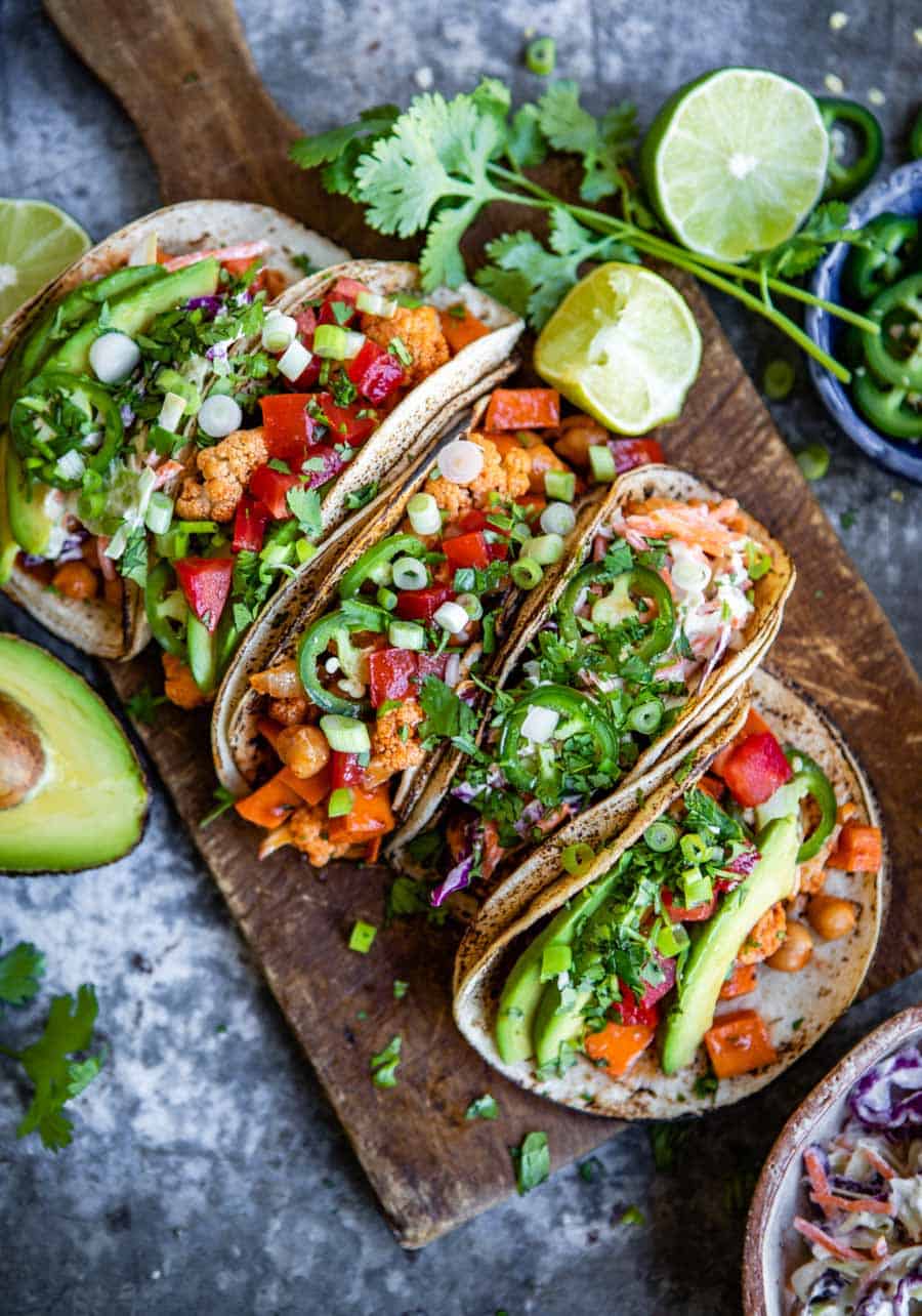 Several Austinite vegan tacos on a wooden board.